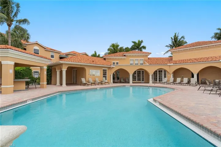 Community pool with a patio area and french doors