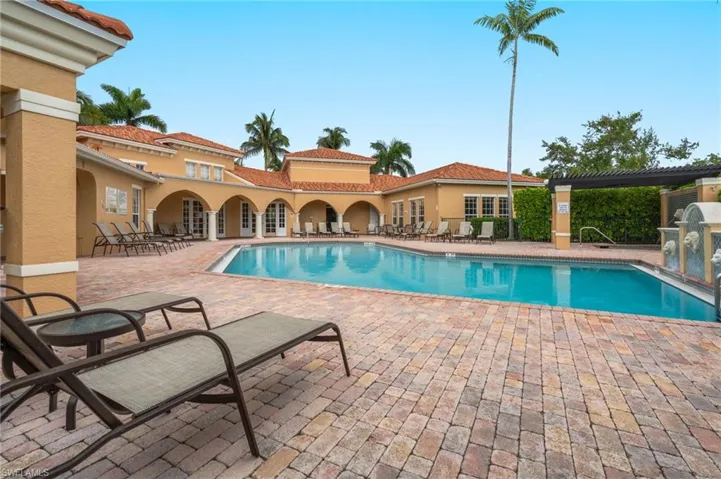 Community pool with a patio