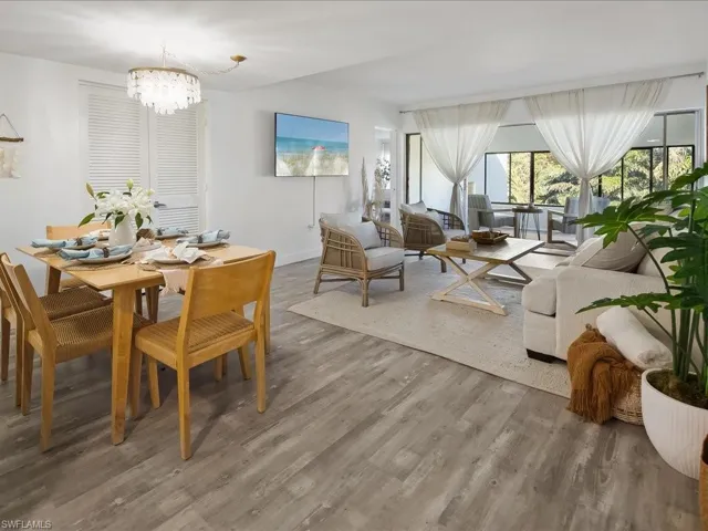 Enhanced by a new capiz shell chandelier, the open dining area with mirrored wall brings abundent light into the living area.