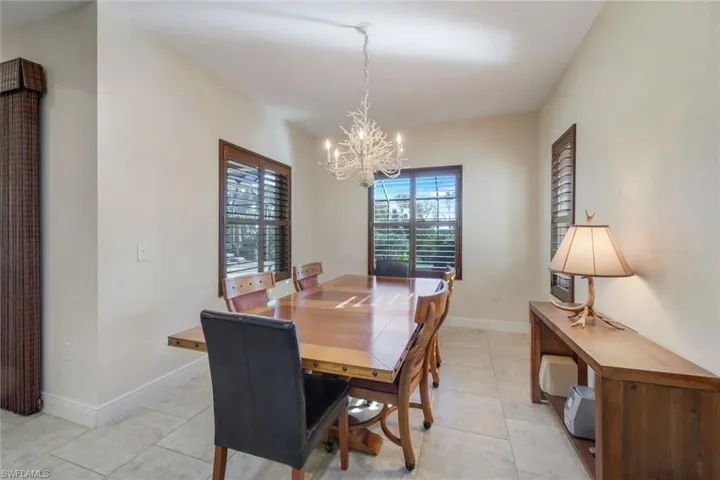 Dining area featuring light tile patterned floors and a chandelier