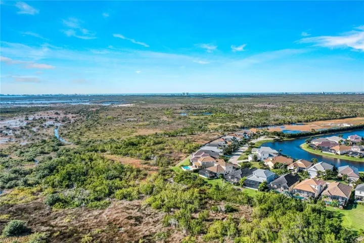 Aerial perspective of suburban area featuring a large body of water