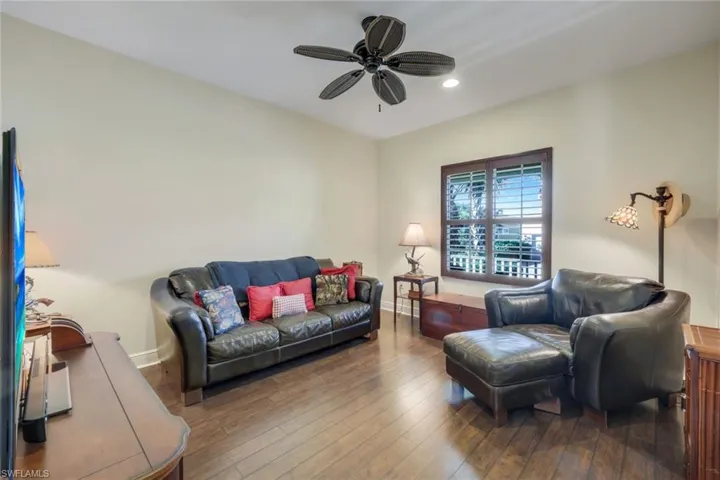 Living room with hardwood / wood-style flooring, ceiling fan, and recessed lighting