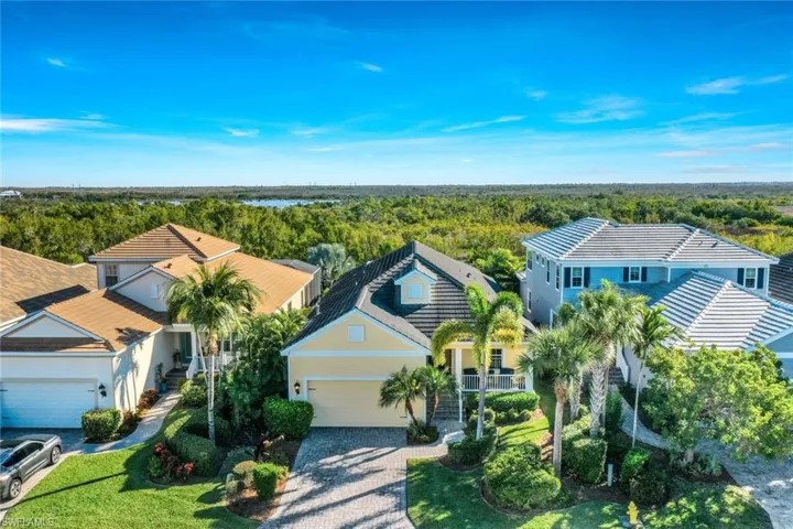 Aerial view of property and surrounding area with a heavily wooded area