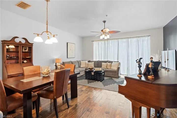 Dining area featuring suspended lighting, hardwood / wood-style floors, and ceiling fan
