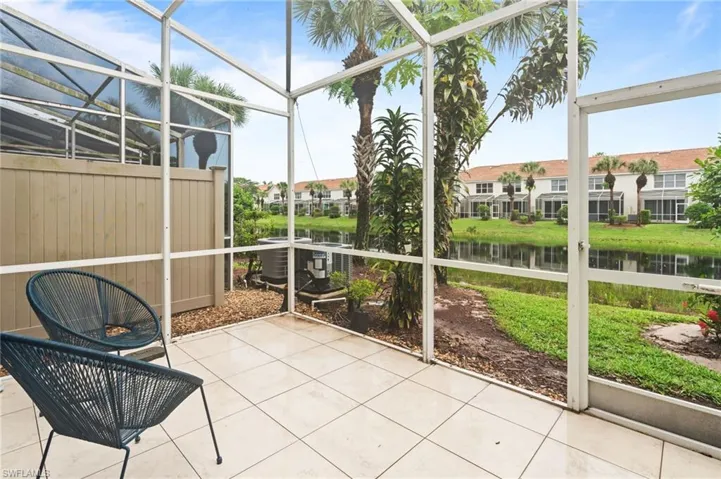 Unfurnished sunroom with a patio area and a water view