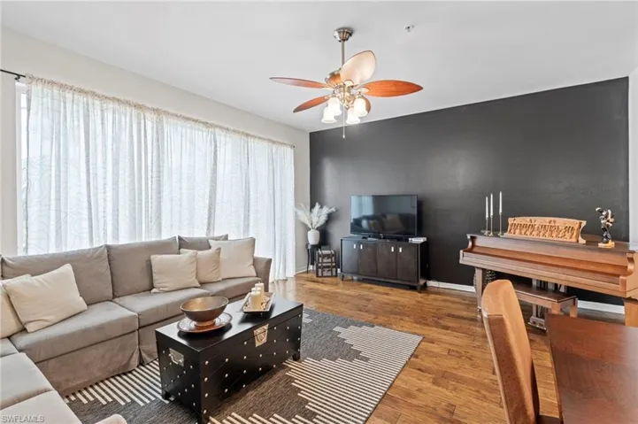 Living room featuring hardwood / wood-style floors and ceiling fan
