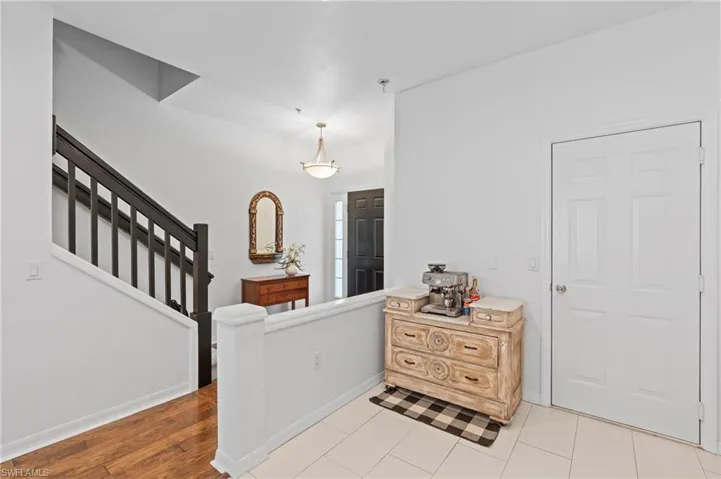 Foyer featuring stairs and light tile patterned floors