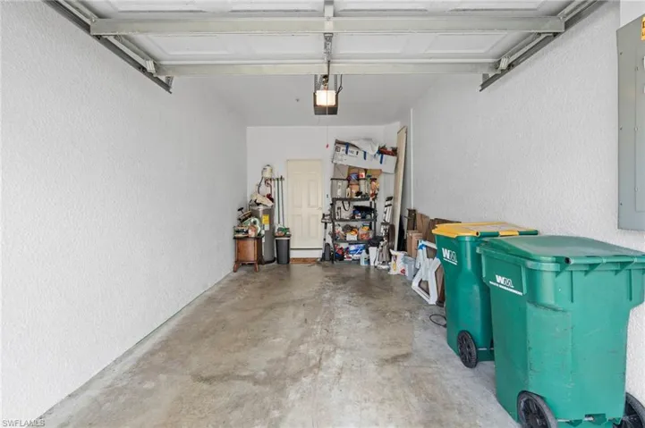 Garage featuring a textured wall and electric panel