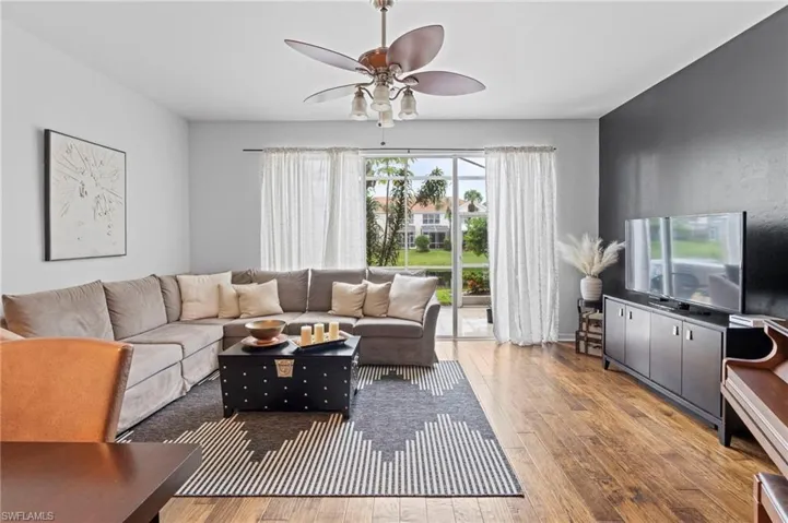Living area featuring ceiling fan and light wood-style floors