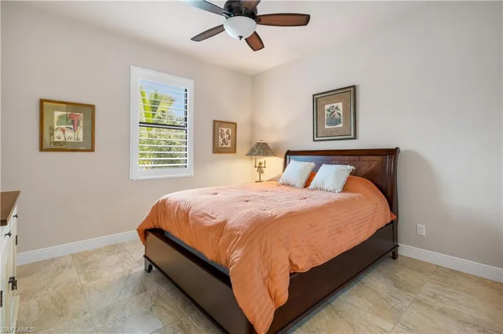 Tiled bedroom with ceiling fan