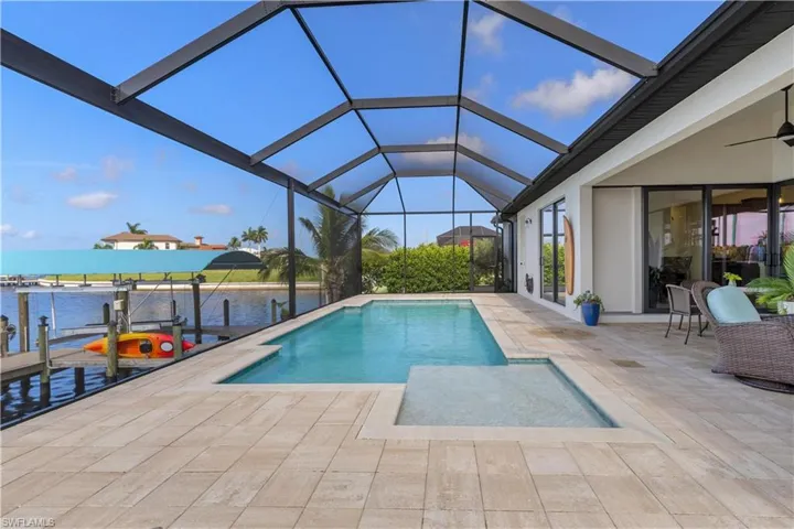 View of pool featuring a water view, ceiling fan, a patio area, and a lanai