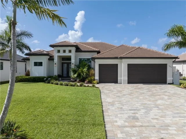View of front of home featuring a garage and a front yard