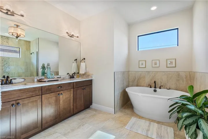 Bathroom featuring double vanity and tile patterned floors