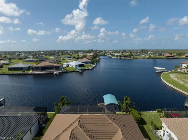 Birds eye view of property with a water view