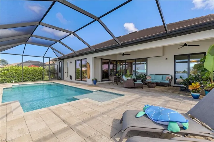 View of swimming pool featuring a lanai, a patio, ceiling fan, and an outdoor hangout area