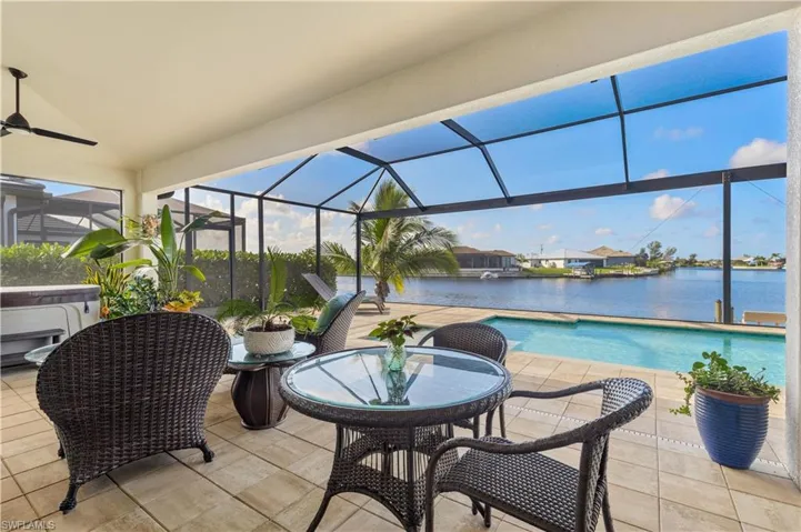 Sunroom with a water view and ceiling fan