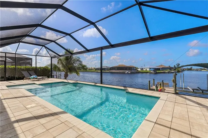 View of pool with a lanai and a patio area