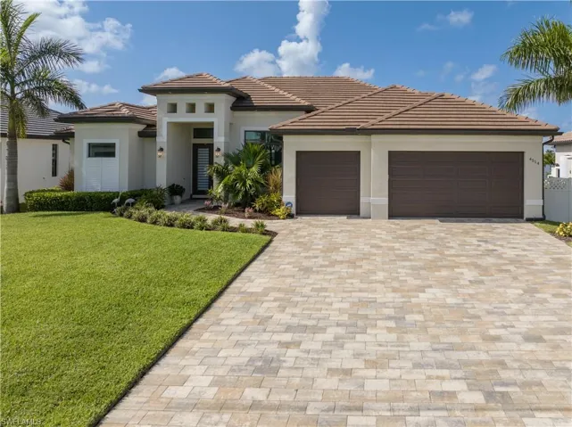 View of front of home with a garage and a front yard