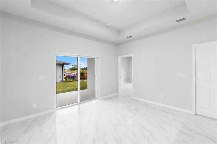 Tray ceilings with all impact sliders providing incredible natural light.  Covered lanai access directly from the living room