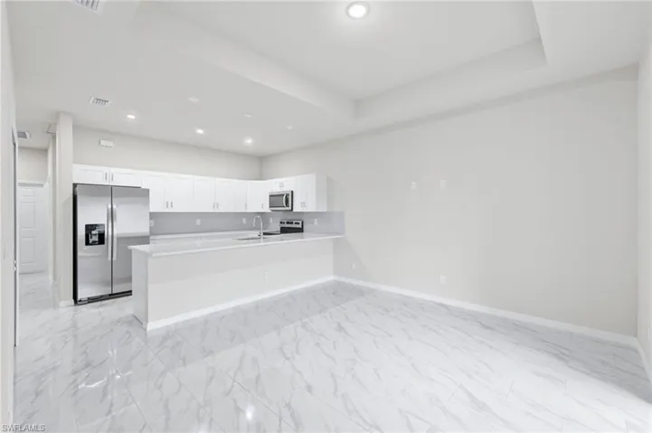 Tray ceilings in the living room with ideal flow from the kitchen.