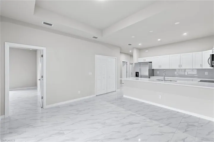 Tray ceilings in the living room with ideal flow from the kitchen and master bedroom. Washer/Dryer laundry centrally located for easy access and storage.