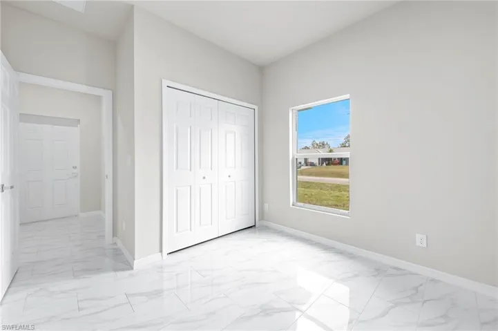 Bedroom 2 - patterned floors with large closet.