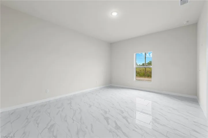 Bedroom 2 - patterned floors.  Large windows for great natural light.
