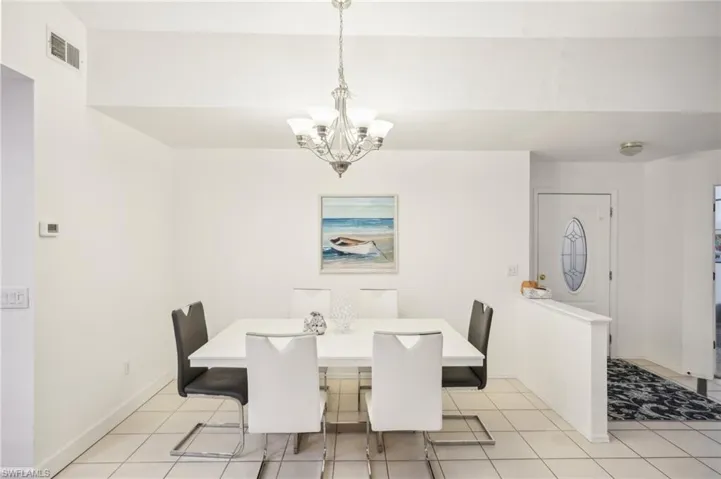 Tiled dining space with an inviting chandelier