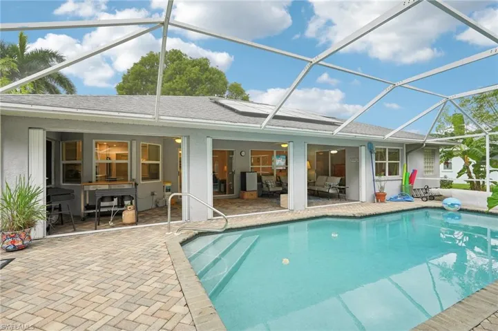 View of swimming pool with a lanai and a patio area