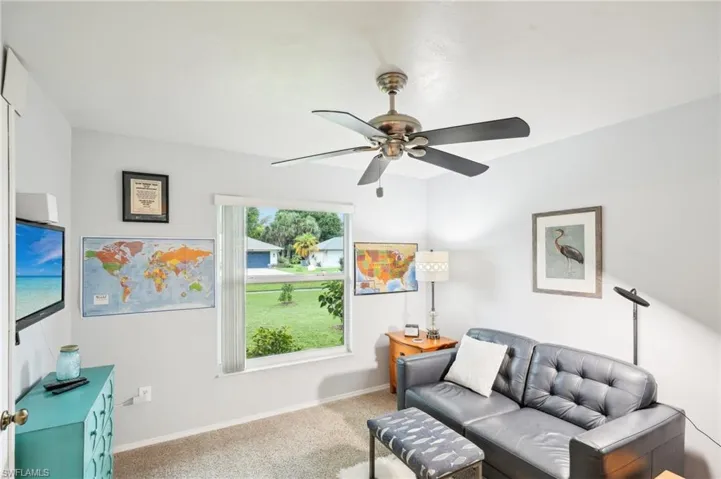 Living room featuring carpet floors and ceiling fan