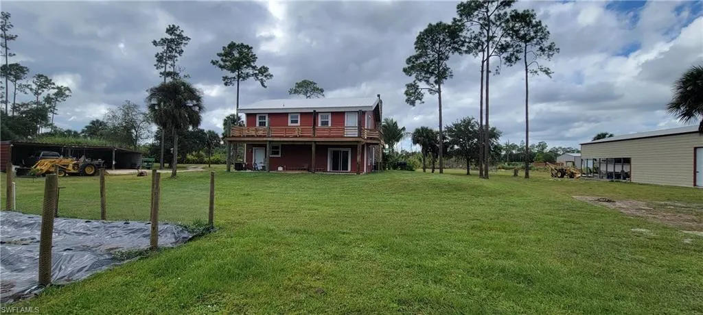 View of grassy yard with a wooden deck