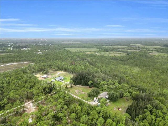 Aerial overview of property's location featuring a forest