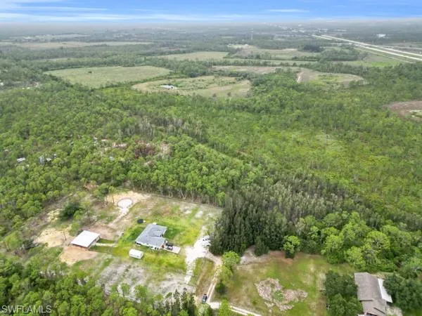 Aerial view of property's location with a heavily wooded area
