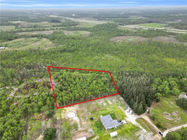 Aerial view of property and surrounding area with a forest and property boundaries highlighted