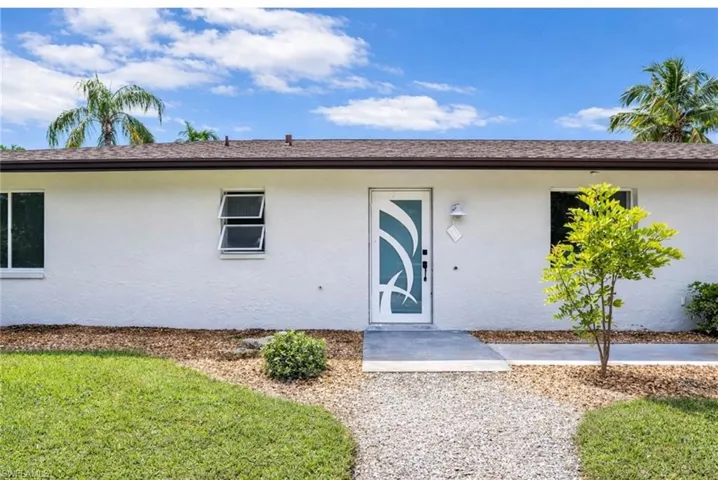 Virtual photo Entrance to property featuring stucco siding and roof with shingles