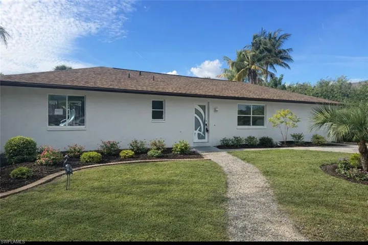 Virtually PhoteRanch-style home featuring a front yard, stucco siding, and roof with shingles