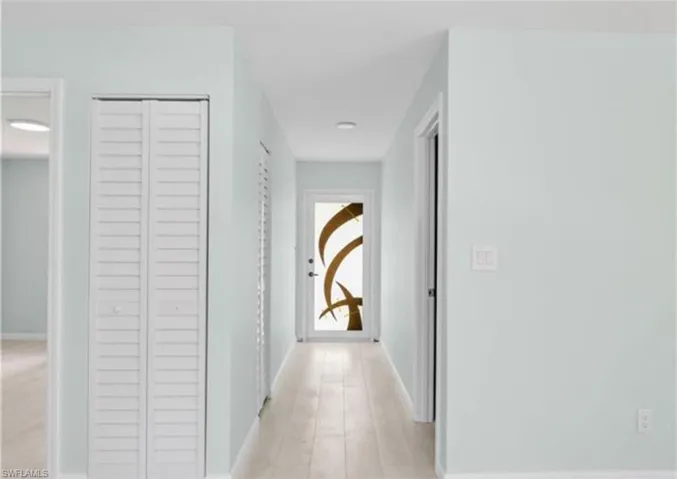 Hallway featuring baseboards