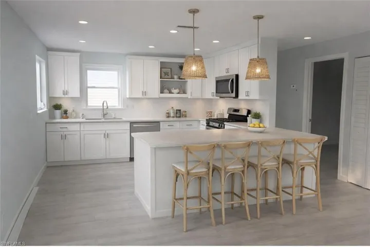 Virtual Kitchen featuring open shelves, a peninsula, a breakfast bar area, appliances with stainless steel finishes, and white cabinetry