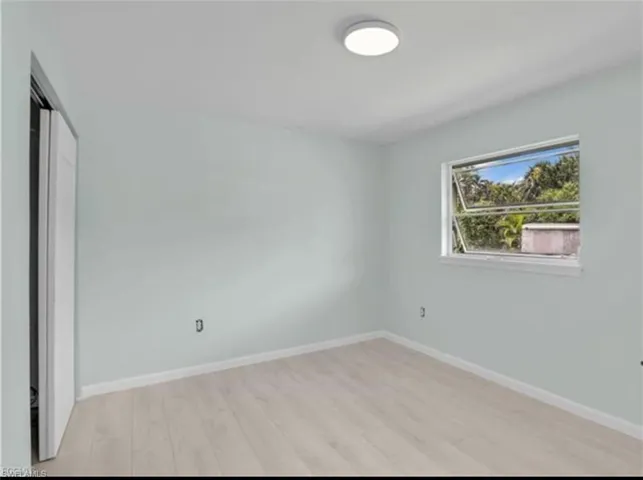 Unfurnished bedroom with a closet and light wood finished floors