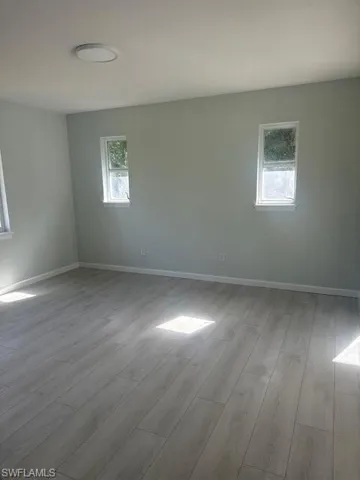 Empty room featuring light wood-type flooring and baseboards