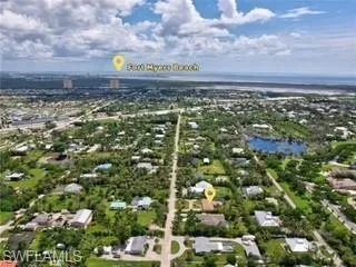 Aerial view of residential area featuring a large body of water