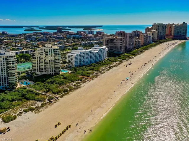 Drone / aerial view with a water view and a beach view