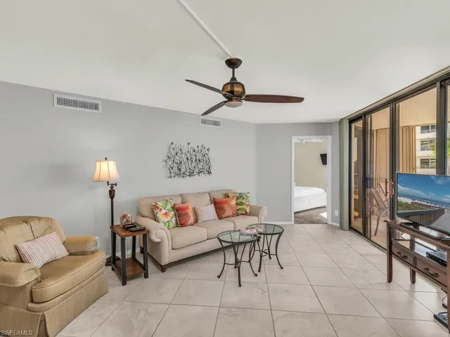 Tiled living room featuring ceiling fan