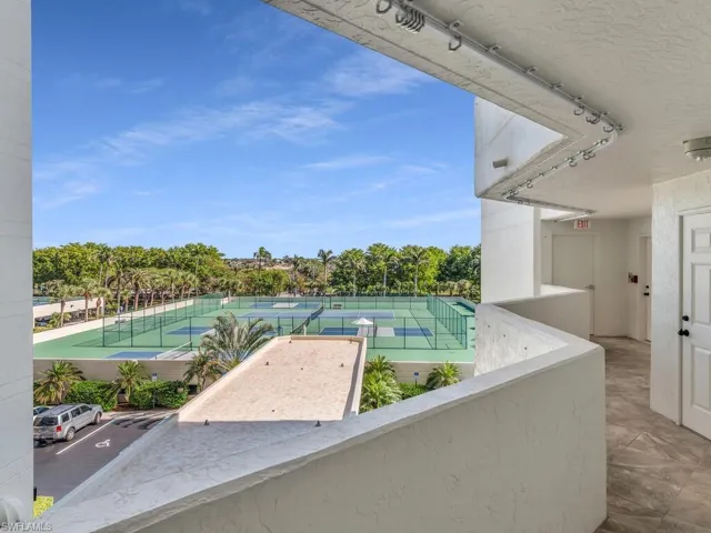 View of pool with tennis court