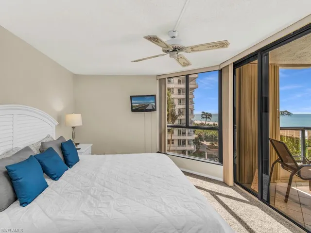 Carpeted bedroom with ceiling fan