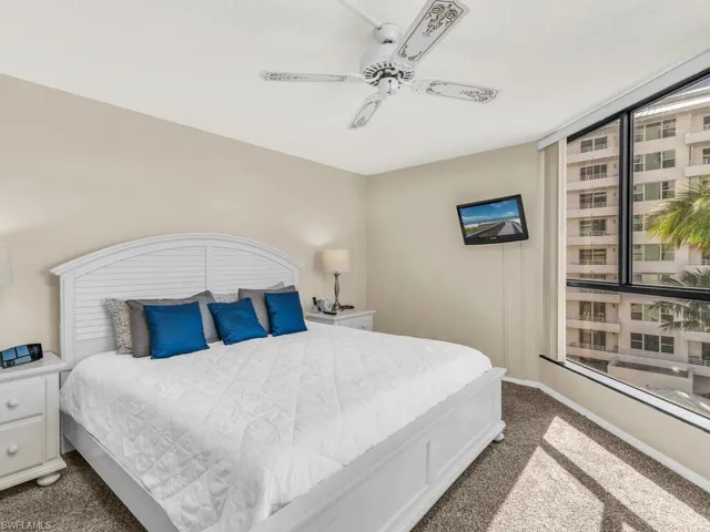 Carpeted bedroom with ceiling fan