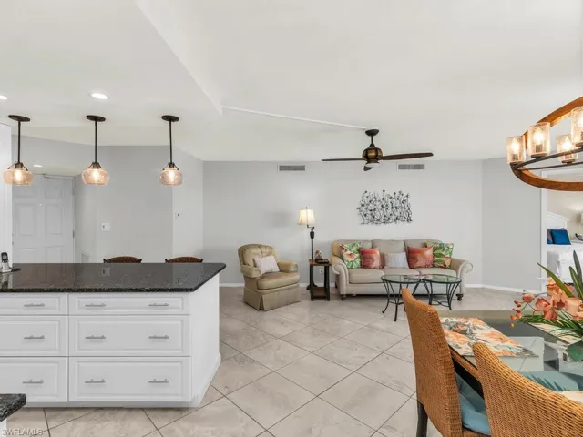 Tiled living room featuring ceiling fan