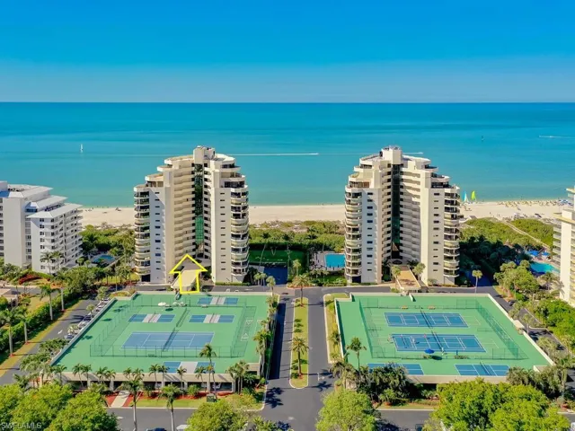 Aerial view featuring a water view and a view of the beach