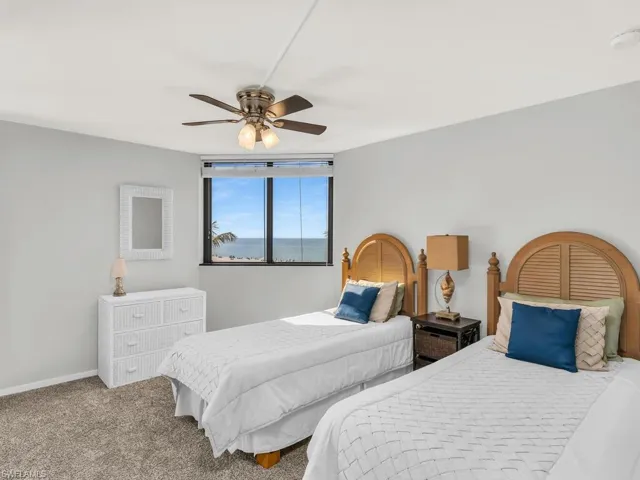 Carpeted bedroom with ceiling fan