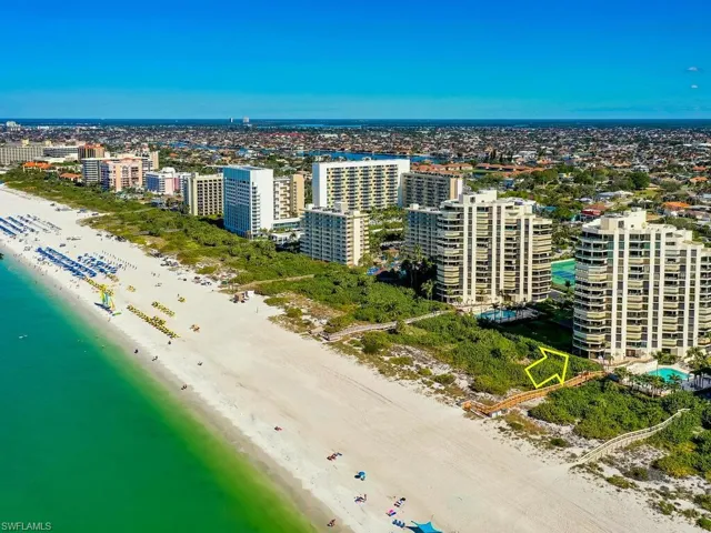 Aerial view featuring a water view and a beach view